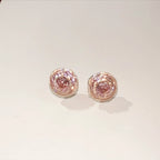 Pair of pink gemstone earrings on a light gray background