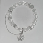 Necklace with clear beads and silver chain on a light gray background