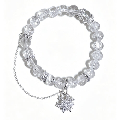 A clear crystal beaded bracelet with silver-toned chain and snowflake charms, displayed on a clean white background.