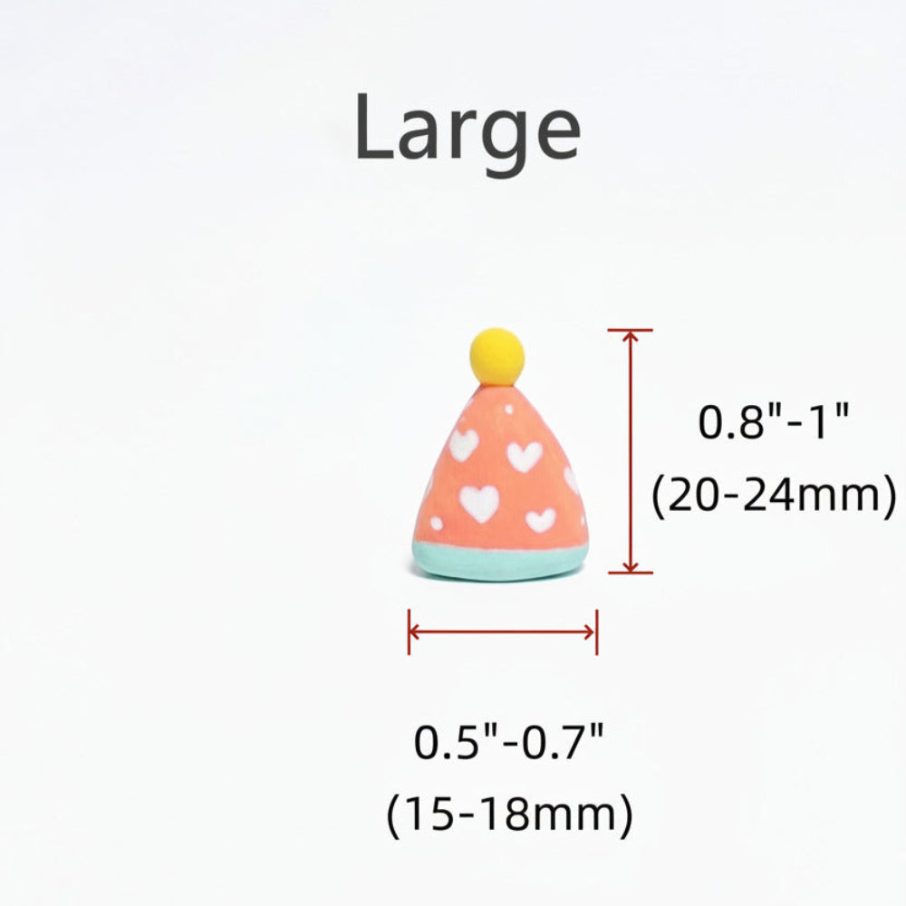 A small party hat-shaped accessory shown with dimension labels for the large size, on a plain white background. The hat is peach with white heart patterns, a light blue base, and a yellow top, with red measurement arrows and text indicating height and width.