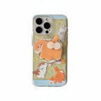 A clear iPhone case decorated with cute cartoon cats in orange, white, and brown, set against a pale yellow background with small star details. The case is shown on a plain white background.
