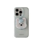 A speckled light gray phone case with a 3D white polar bear pop socket featuring a light blue bow, shown on a white background.