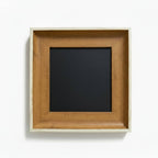 A square wooden picture frame with a natural light oak finish and a black center mat, shown against a plain white background.