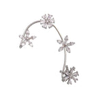 Silver snowflake-shaped earring on a white background