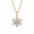 Gold necklace with a snowflake pendant on a white surface
