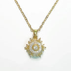 Gold necklace with a decorative pendant on a white background