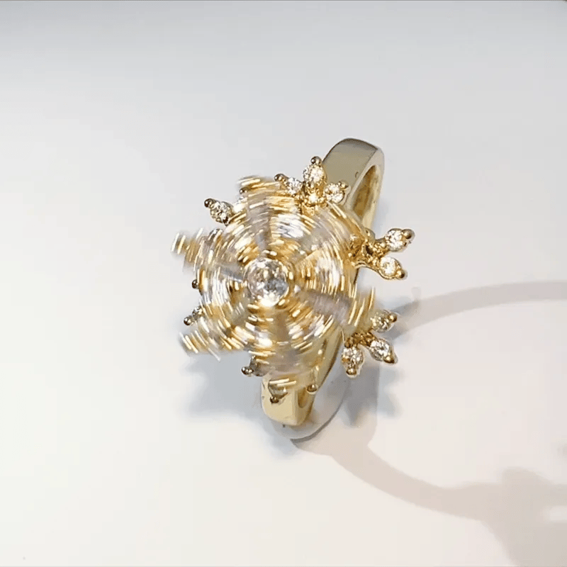 Gold ring with intricate design on a white background
