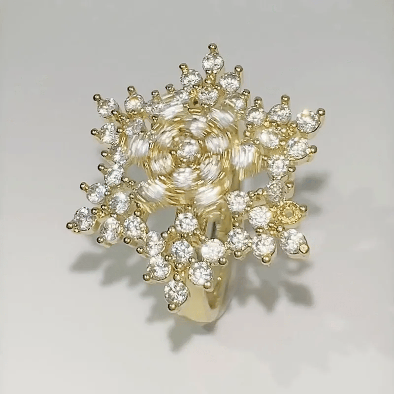 Gold ring with diamond accents on a light gray background