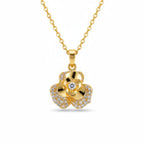 A gold flower pendant necklace on a delicate gold chain, featuring a central clear gemstone surrounded by small pavé-set clear stones, shown against a plain white background.