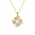 Gold necklace with a pendant featuring a pearl and diamonds on a white background