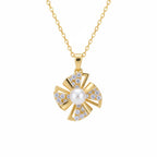 Gold necklace with a pendant featuring a pearl and diamonds on a white background