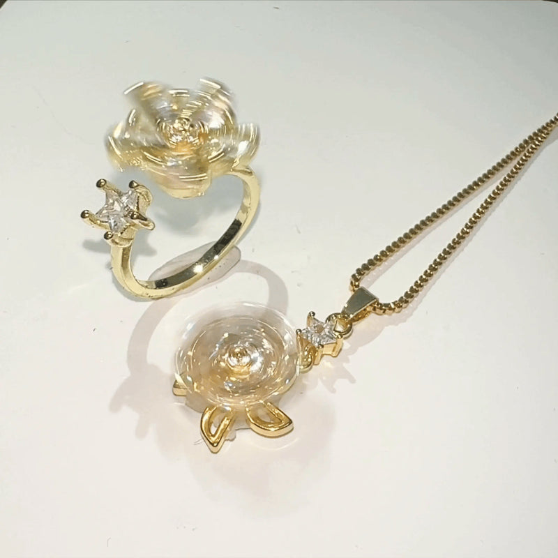 Gold jewelry set with turtle pendant and ring on a white background