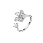 A silver-tone open ring featuring a flower-shaped setting with clear marquise-cut gemstones and a small central cluster of round stones, shown on a plain white background.