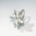 Metallic butterfly-shaped object on a white background